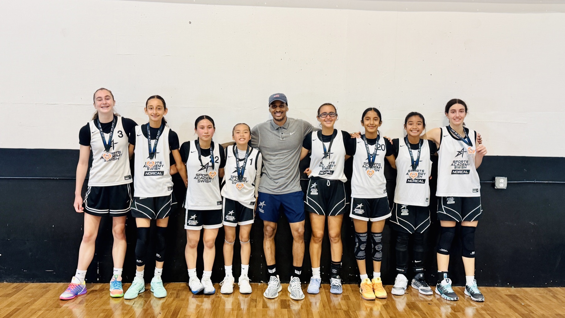 A WE girls team with their first-place medals