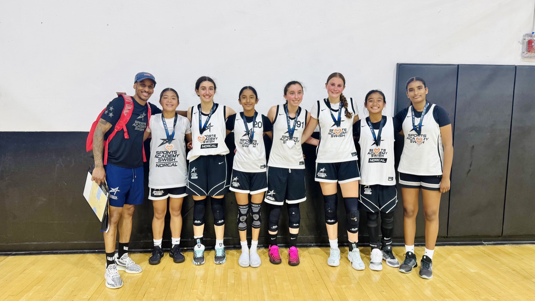 A WE girls team with their tournament medals